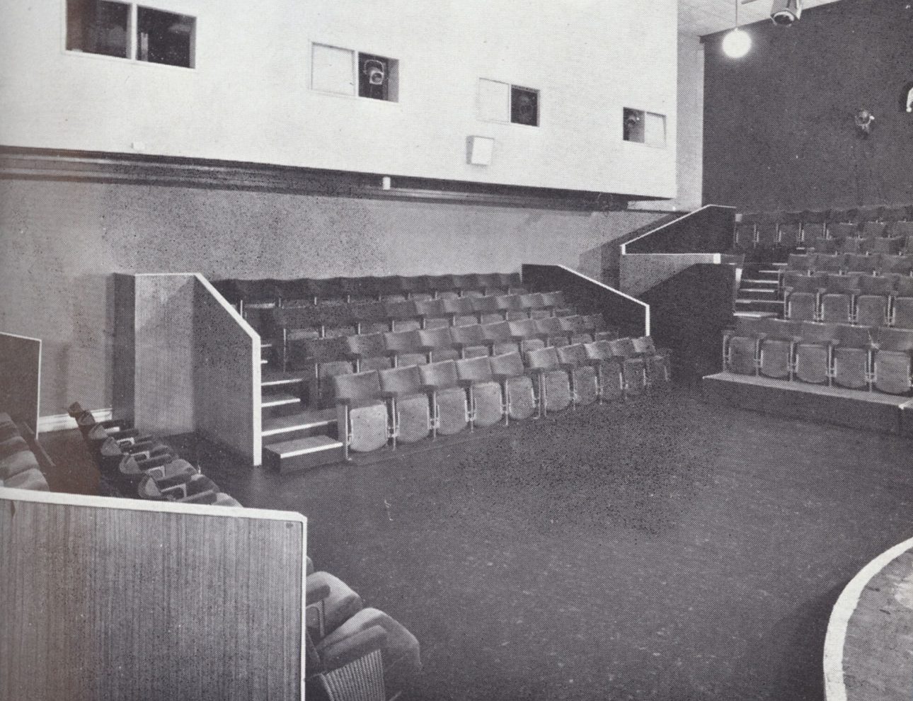 The interior of the Close Theatre. A small stage surrounded by rows of seats.