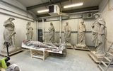 Large stone statues in a workshop.