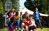 A group of young performers at an outdoor event