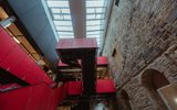 Vibrant pink staircase against old sandstone wall in the new foyer Courtyard of the Citizens Theatre.