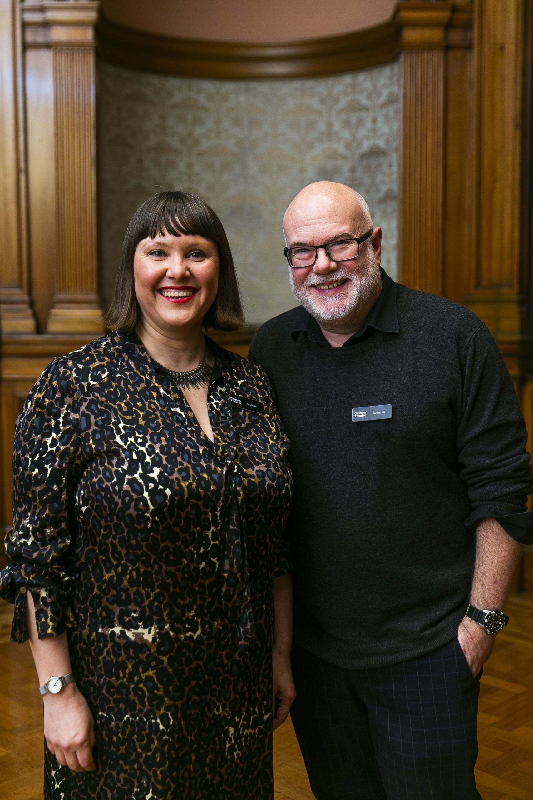 A man and a woman standing together smiling.