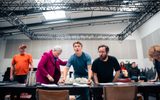 A group of actors in a rehearsal room.