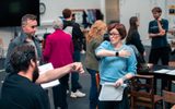 A group of actors in a rehearsal room.