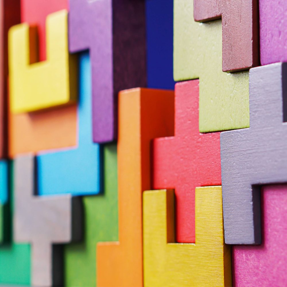 Brightly coloured Tetris blocks stacked together