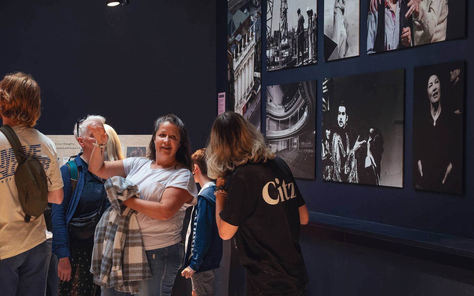 A group of poeple looking at historic photos of the theatre